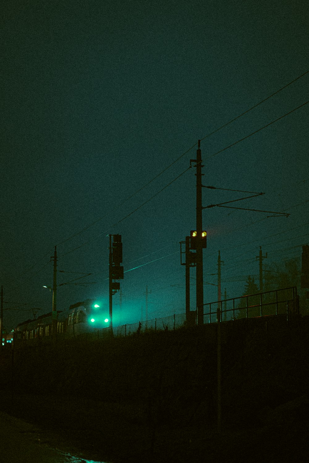 silhouette of electric post during night time