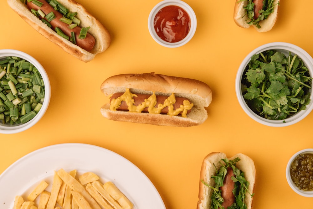 hotdog sandwich with green vegetable on white ceramic plate