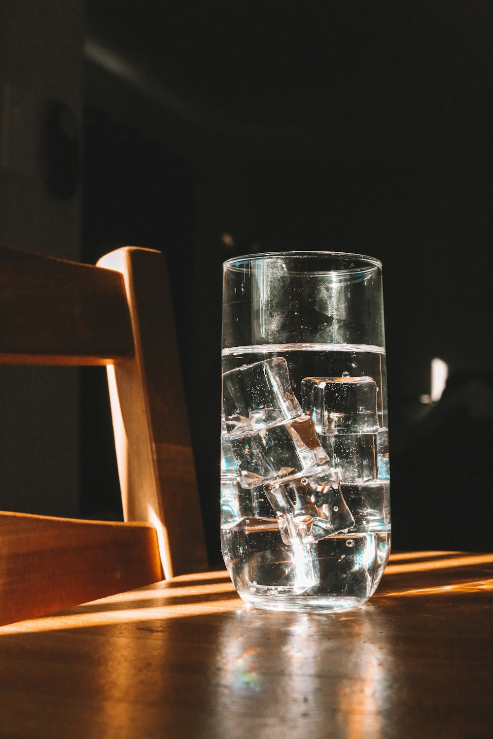 clear drinking glass on brown wooden table