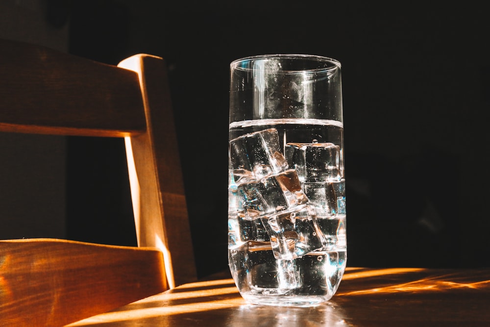 verre à boire clair sur table en bois brun