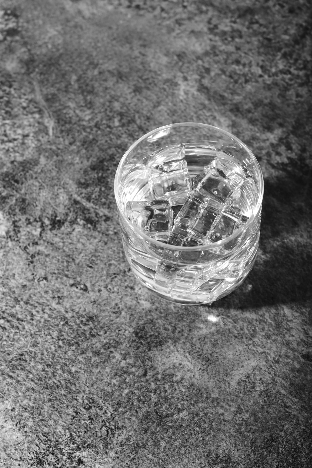 clear glass cup on gray textile