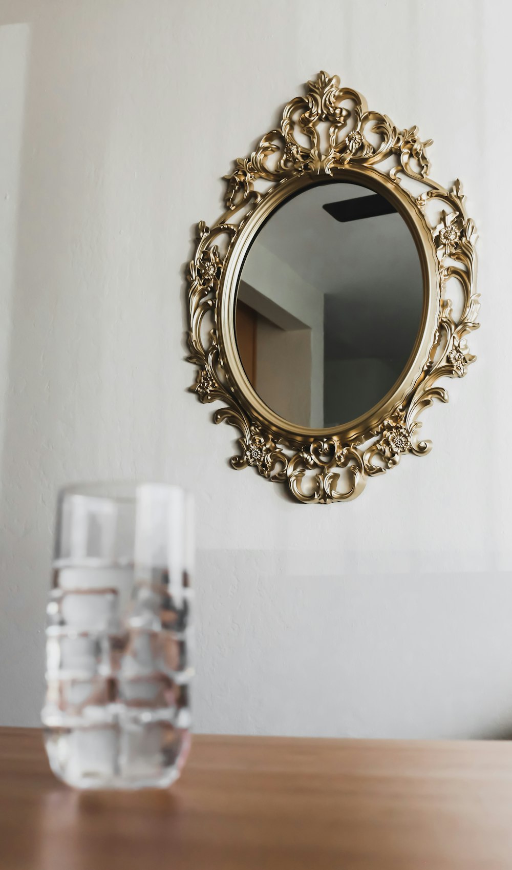 gold framed mirror on white wall