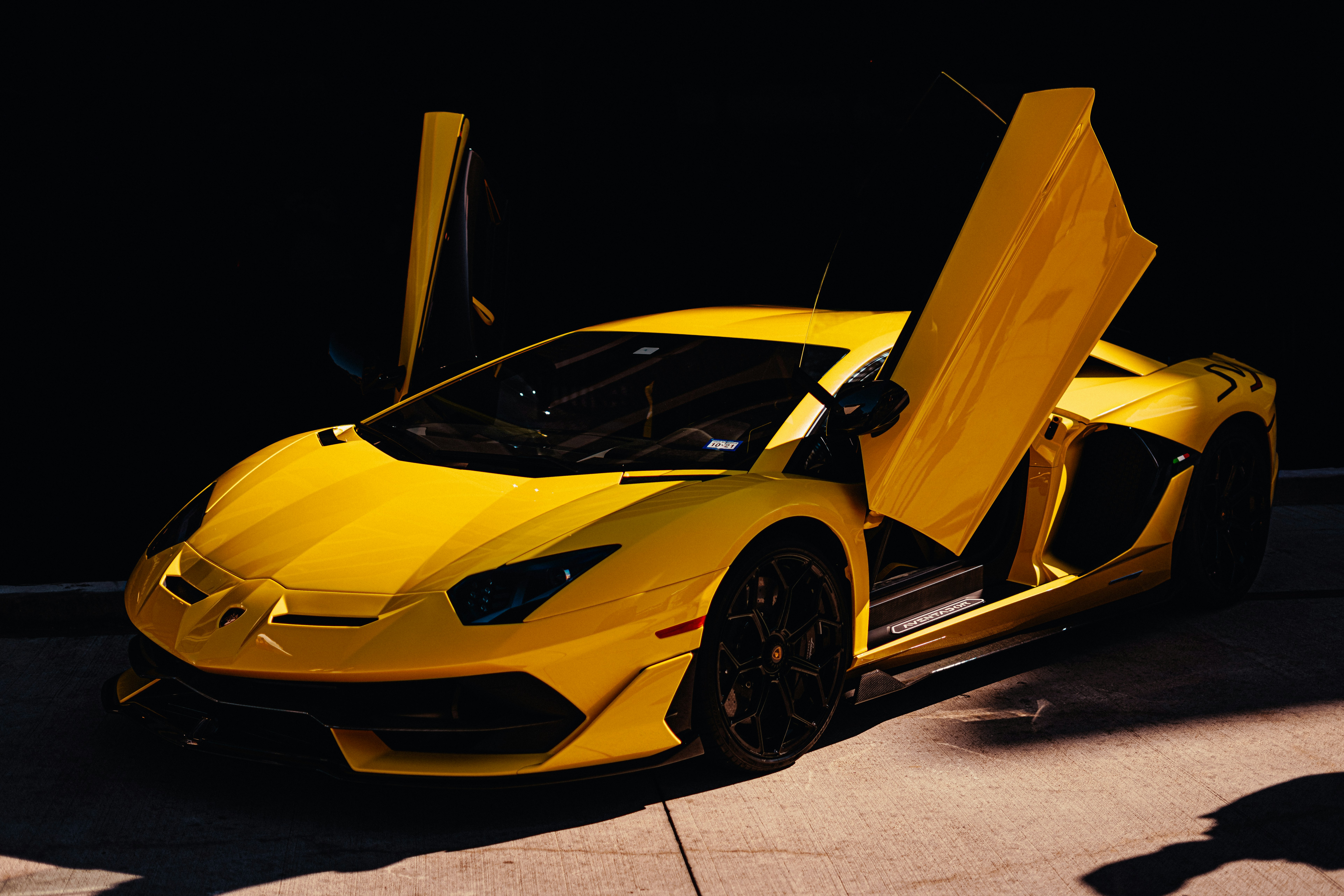 yellow lamborghini aventador in a dark room