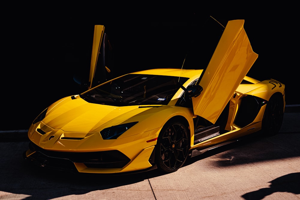 yellow lamborghini aventador in a dark room