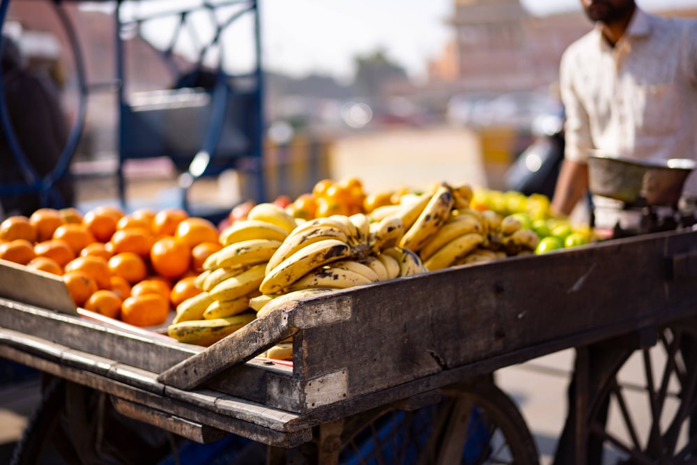 yellow banana fruit on brown wooden crate