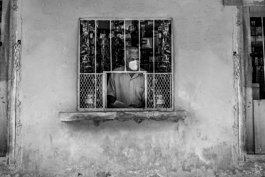 woman in black and white stripe shirt standing in front of window