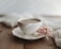 A serene cup of jasmine tea resting on a cream linen cloth with soft morning light.