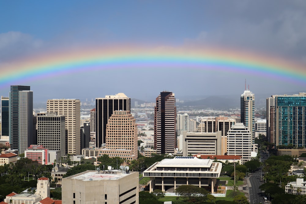 rainbow over city skyline during daytime