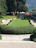A beautifully landscaped lakefront garden with vibrant flowers and manicured lawn.
