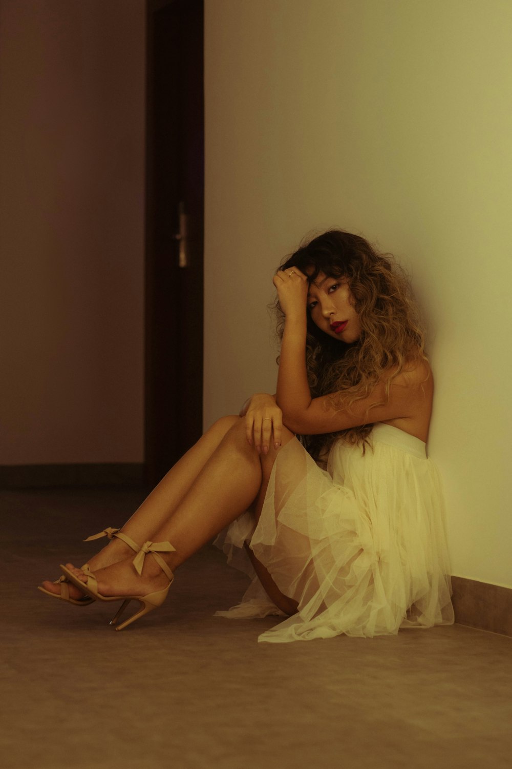 woman in white dress sitting on floor