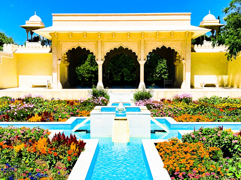 white and blue concrete fountain in front of brown concrete building