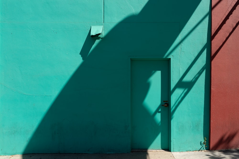 blue painted wall with white pipe