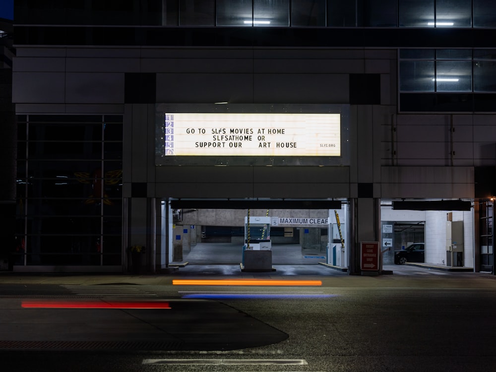 an empty parking garage with a sign on the side of it