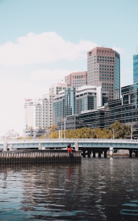 white and brown concrete building near body of water during daytime