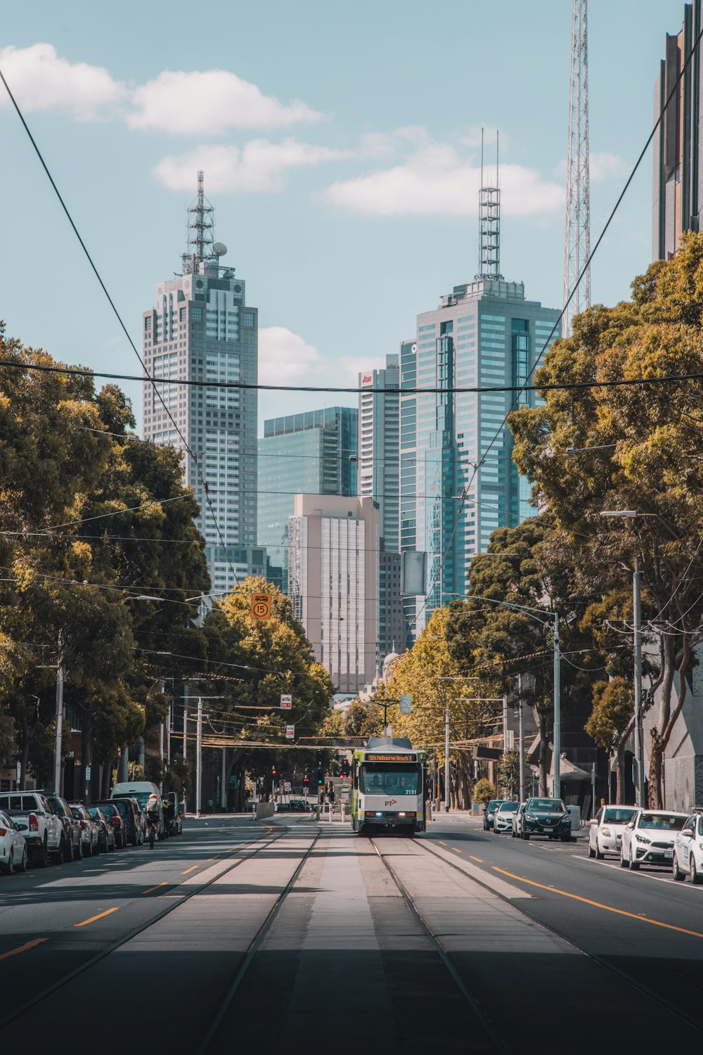 cars on road near high rise buildings during daytime