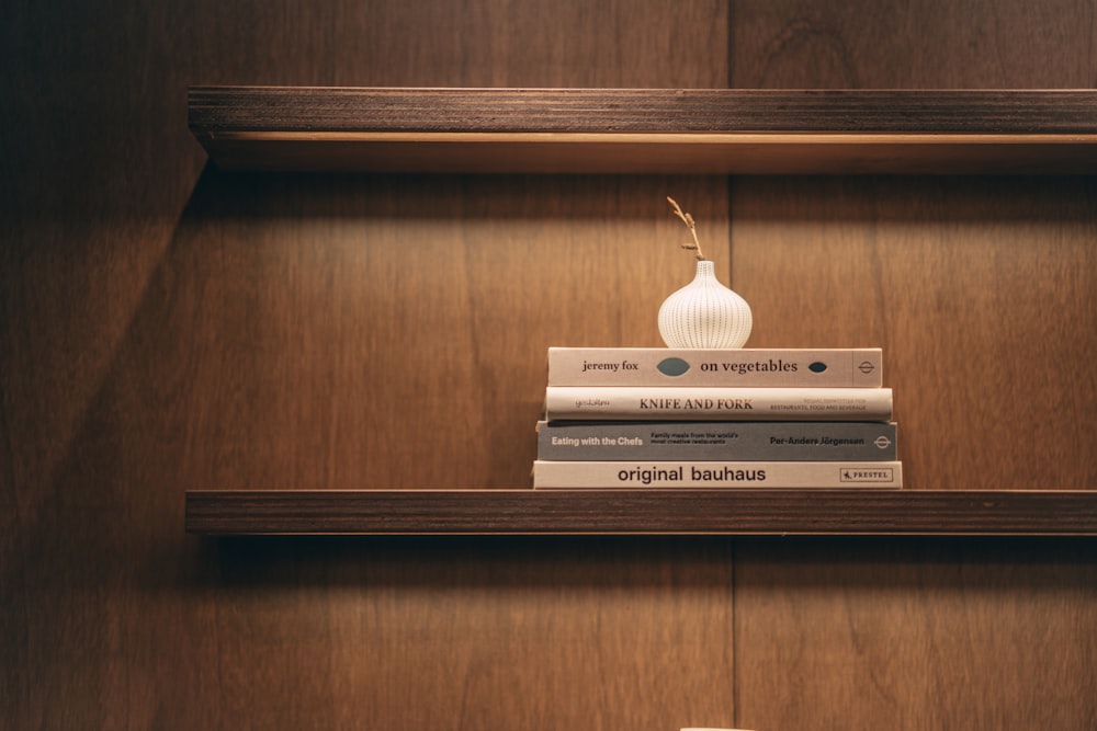 white and black book on brown wooden shelf