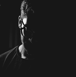 man in black crew neck shirt wearing black framed eyeglasses