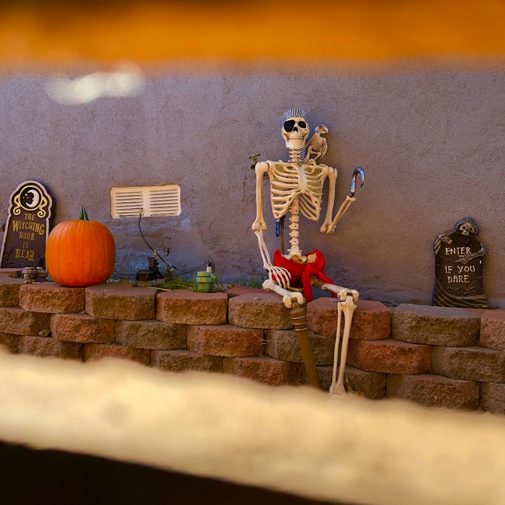 man in red and white costume standing beside brown brick wall during sunset