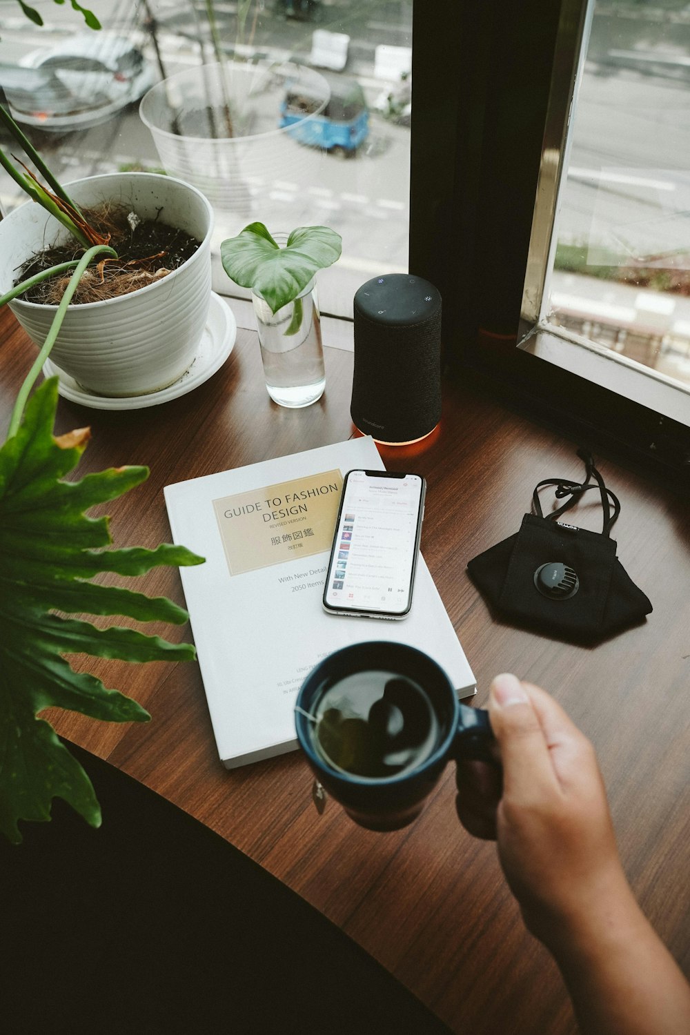 person holding black ceramic mug