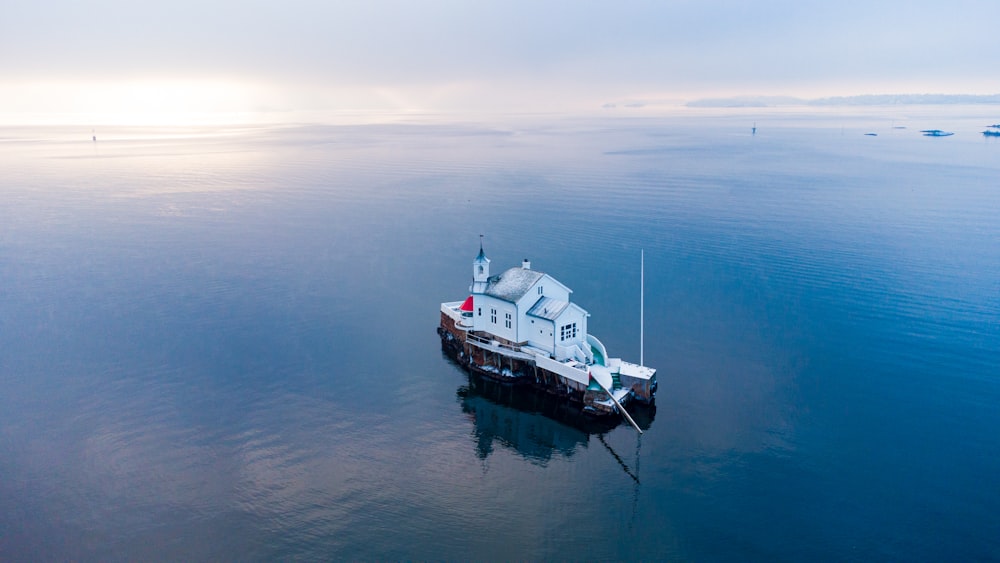 white and red boat on sea during daytime