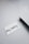 A black pen lies on a smooth, light-colored surface next to a white index card with the handwritten message 'stay healthy'.