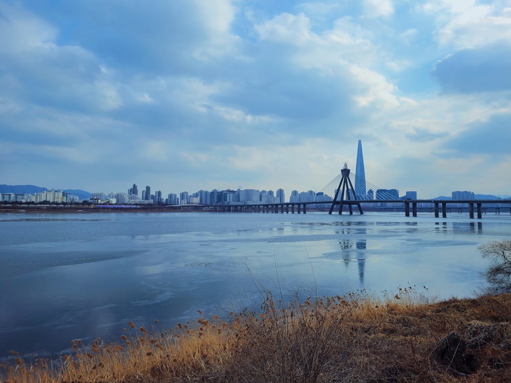 bridge over water under cloudy sky during daytime