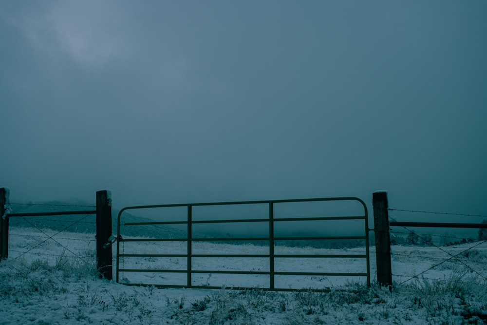 black metal fence on snow covered ground