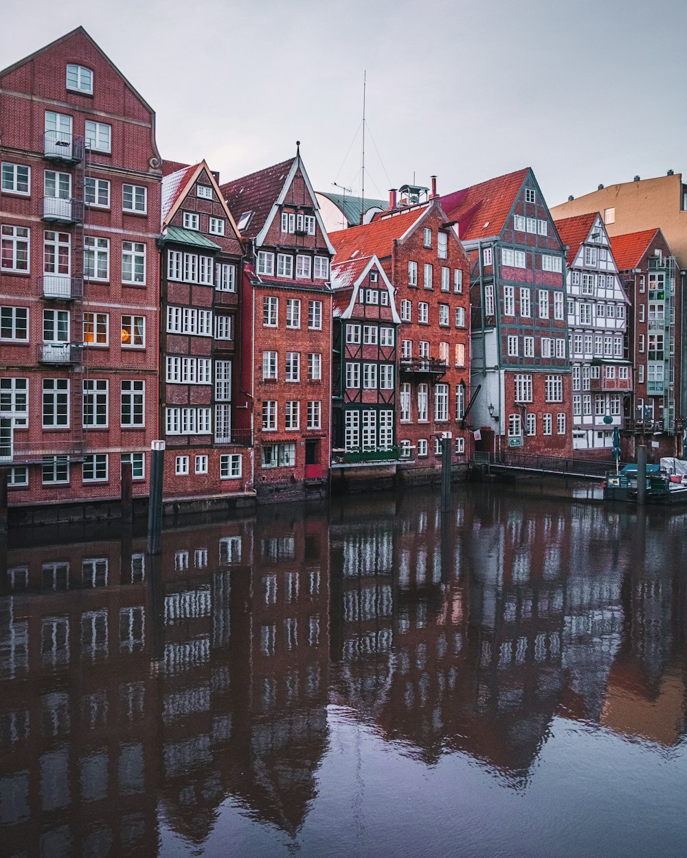 red and white concrete building beside body of water during daytime