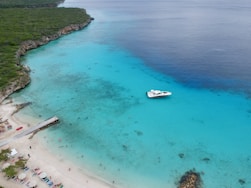 white boat on blue sea water during daytime