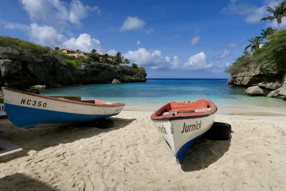 red and white boat on beach during daytime