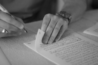 person writing on white paper