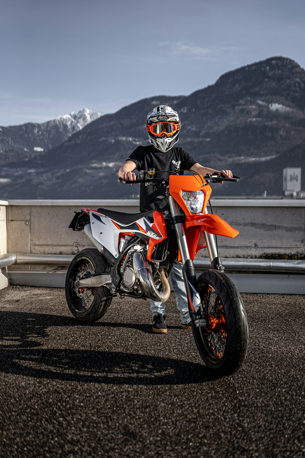 man in orange and black motorcycle suit riding orange and black motorcycle