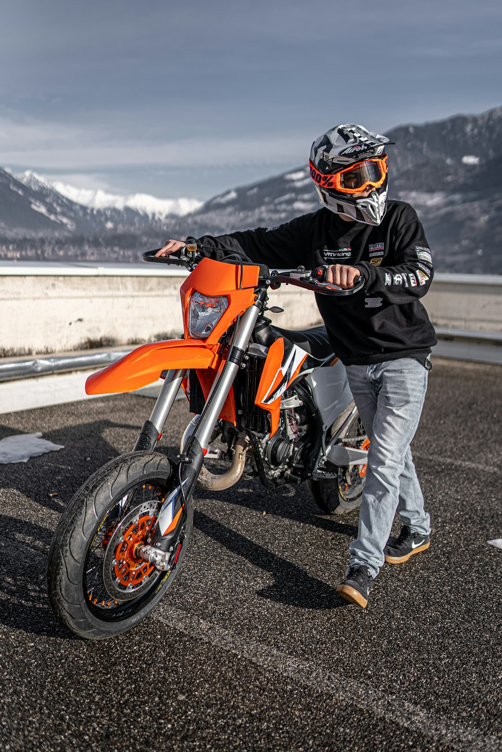 a man riding a motorcycle on top of a road