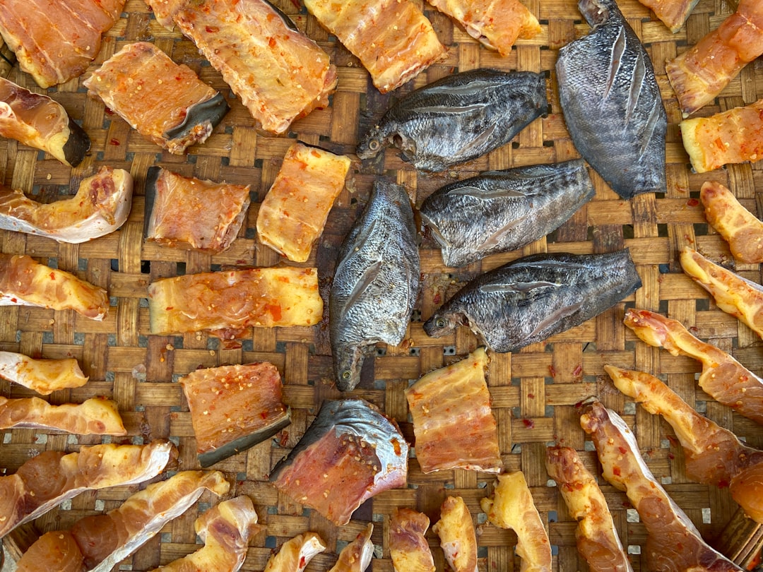 brown and gray fish on brown wooden surface