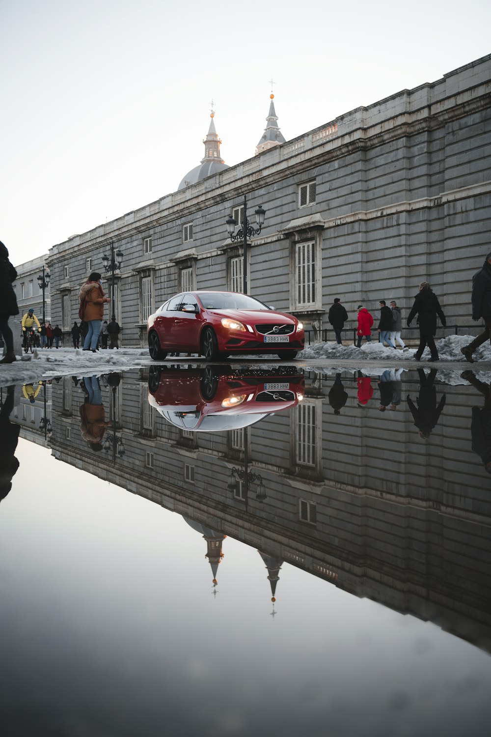 red ferrari sports car on bridge during daytime