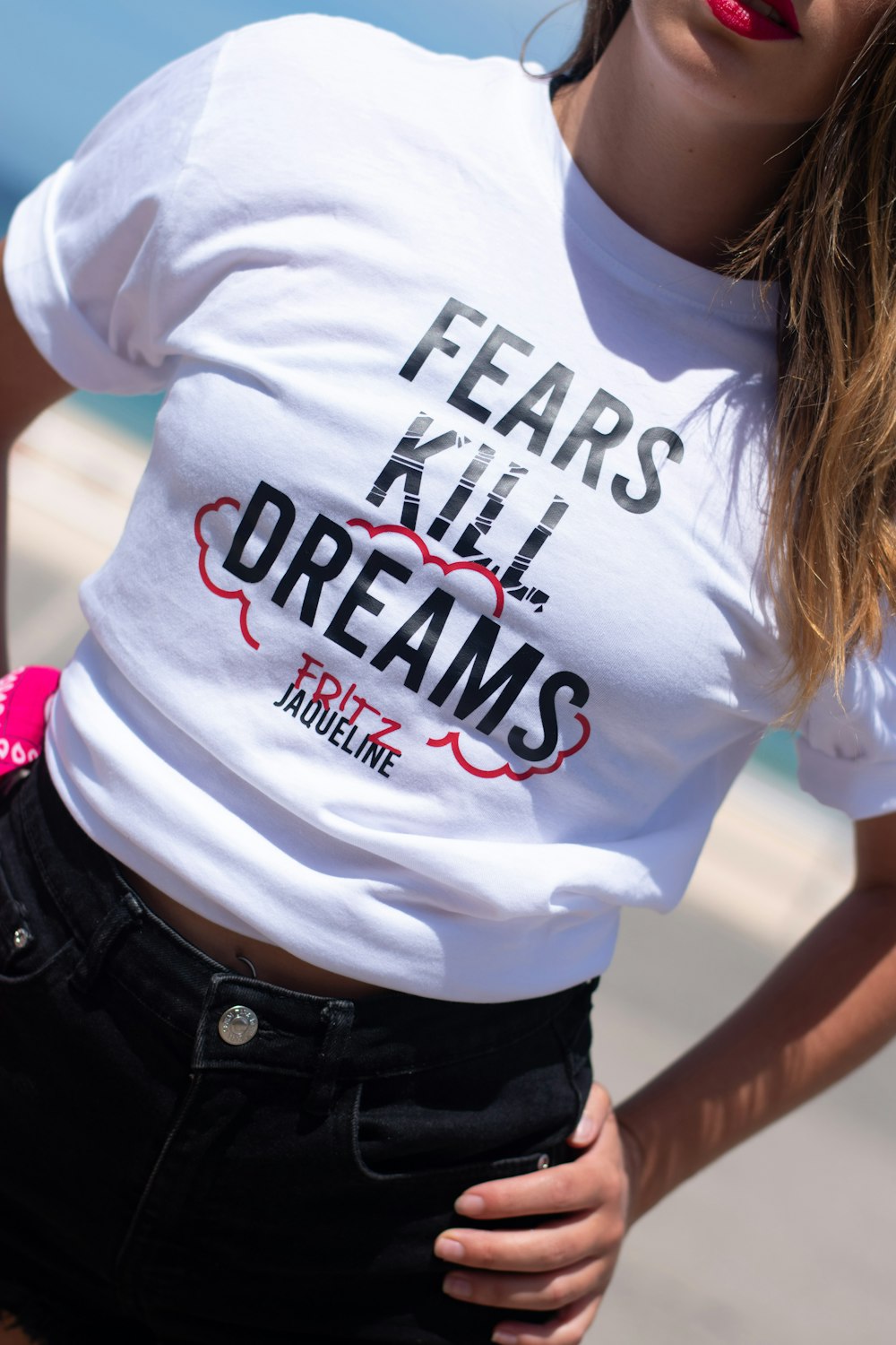 woman in white crew neck t-shirt and black denim bottoms