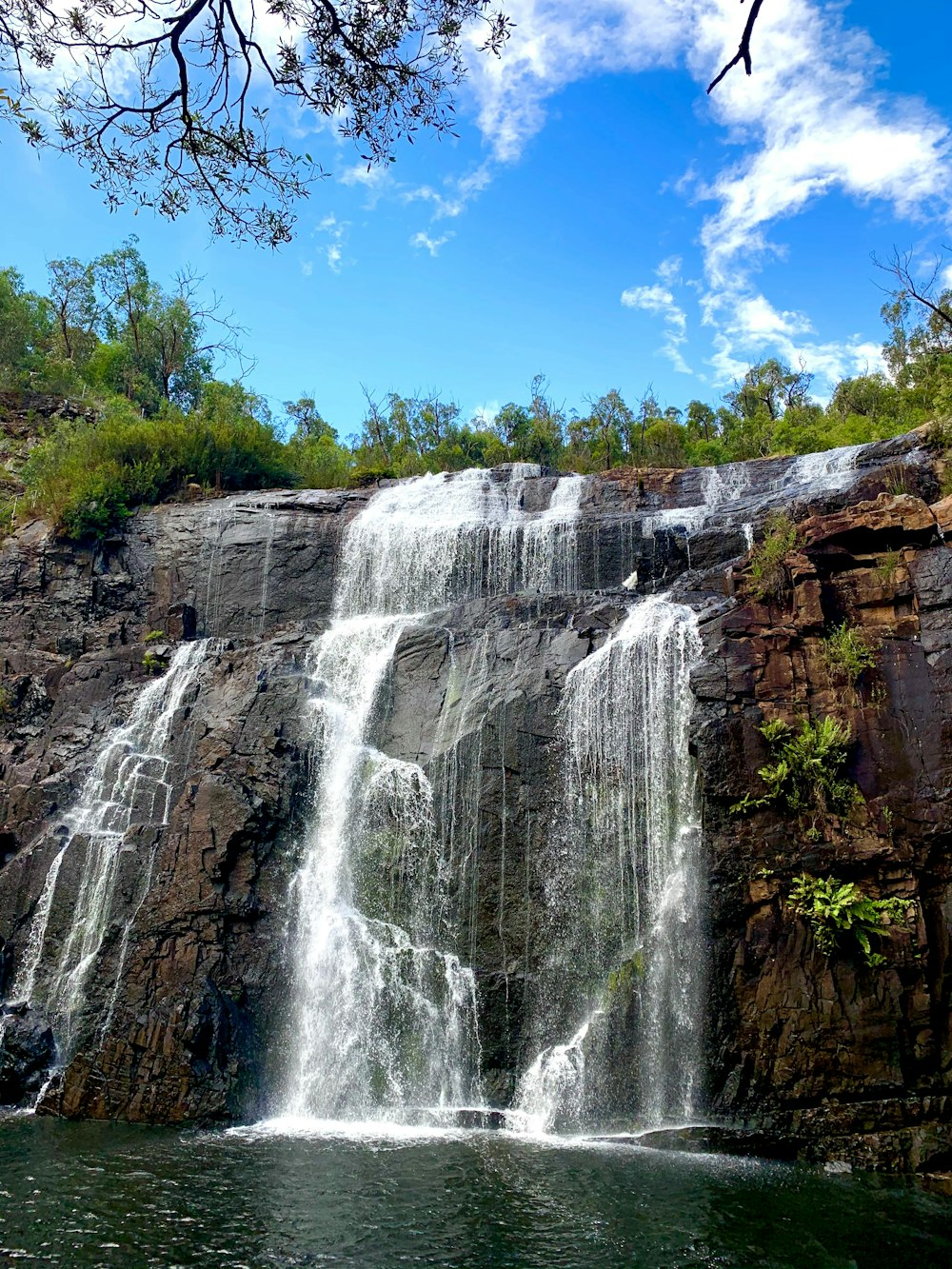 waterfalls under blue sky during daytime