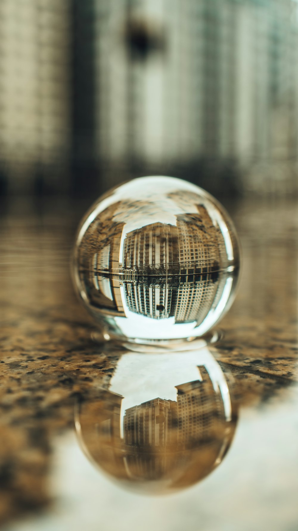 clear glass ball on brown wooden table