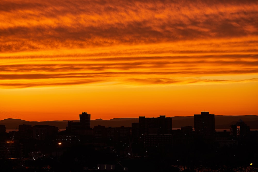 silhouette of city buildings during sunset