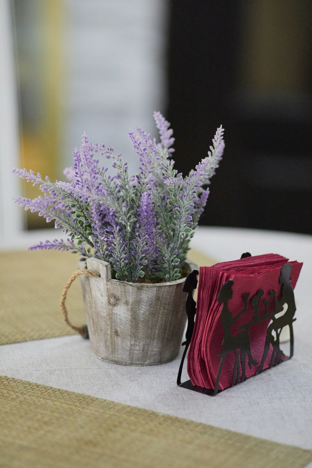 purple flowers in gray steel bucket