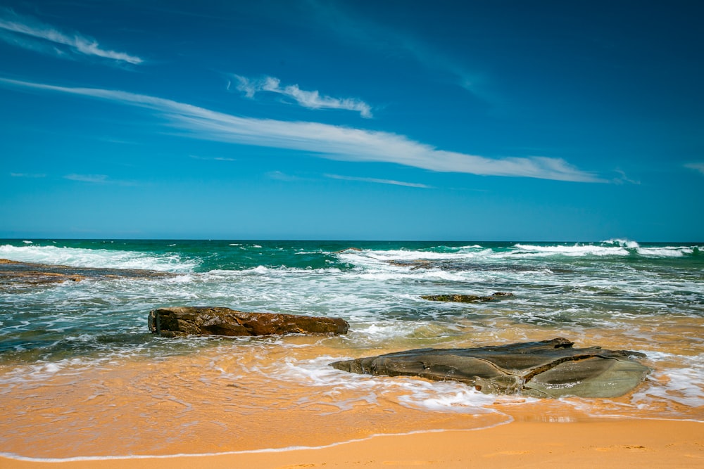 brown rock formation on sea shore during daytime