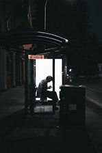 A woman using a mobile app while waiting for her ride in a safe environment.
