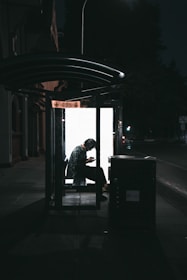 A woman using a mobile app while waiting for her ride in a safe environment.