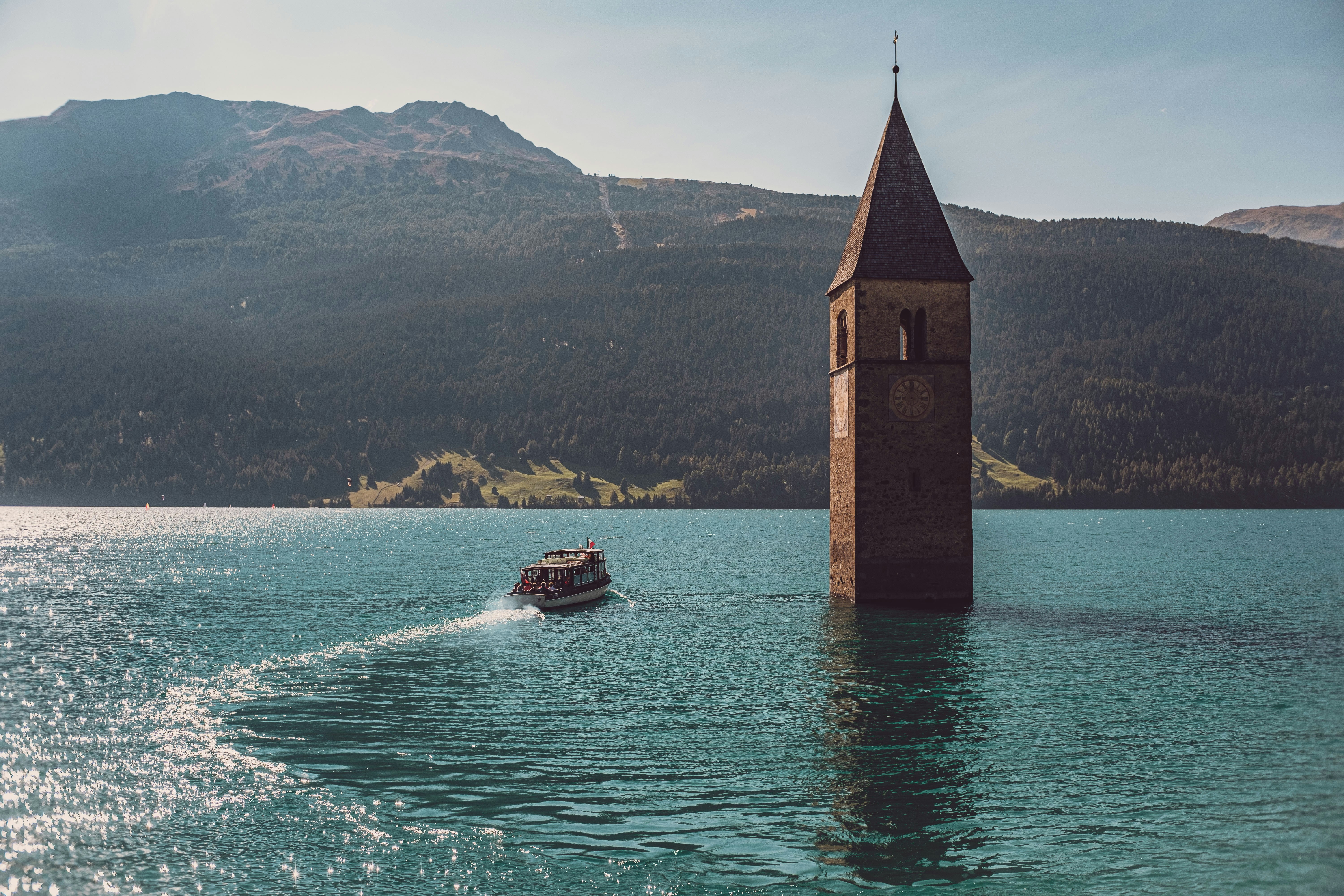 brown and gray concrete building on body of water during daytime, 