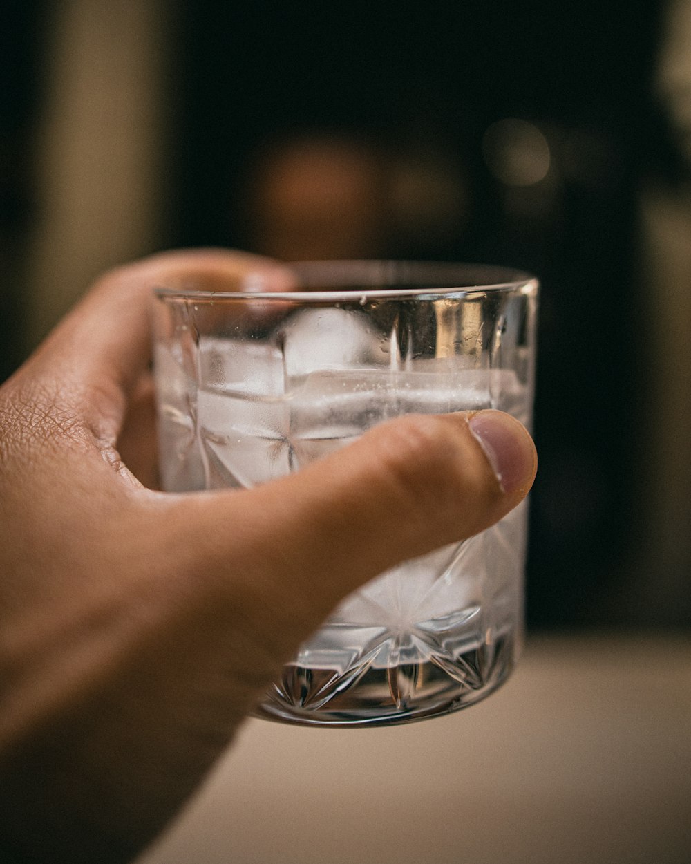 person holding clear drinking glass