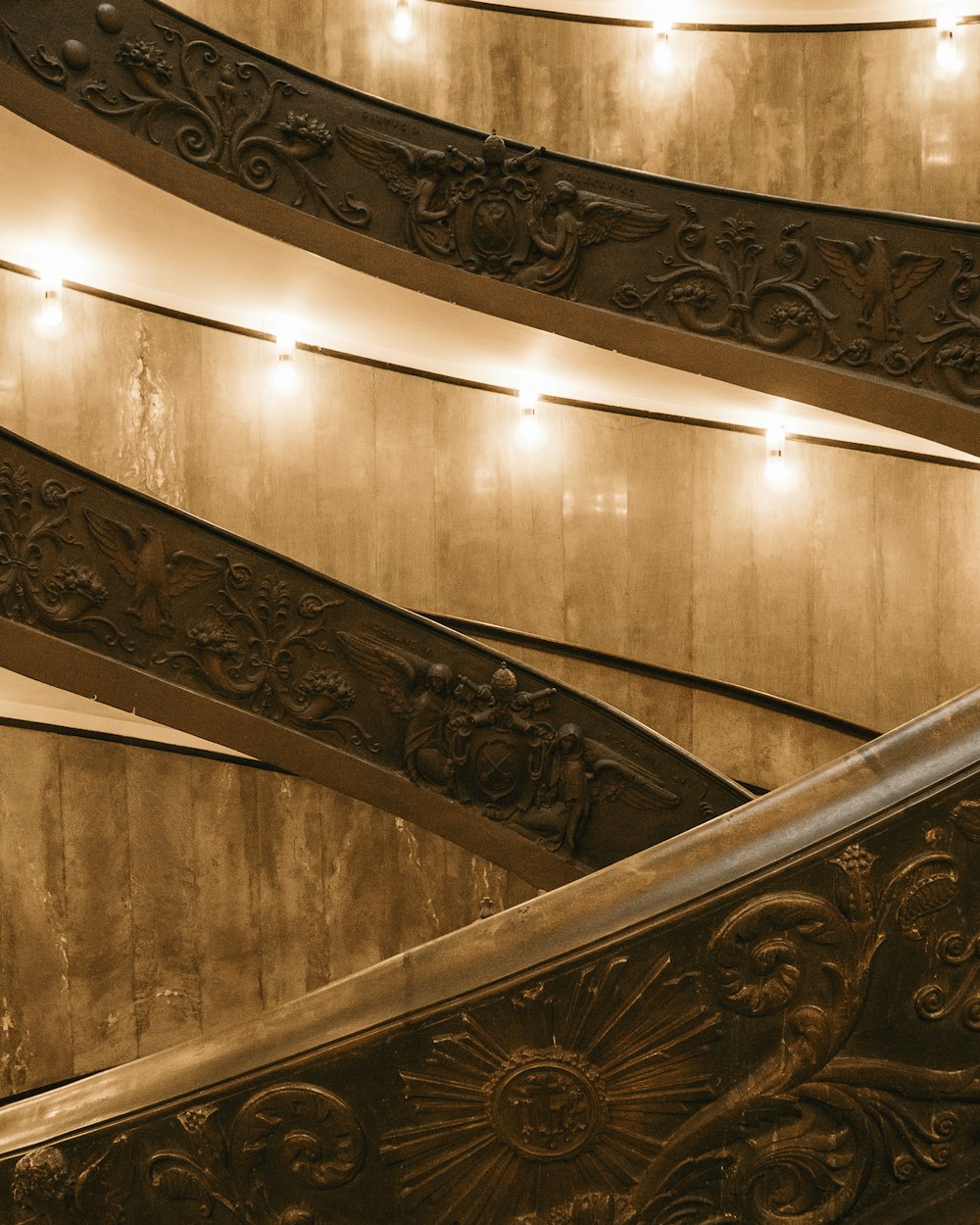 brown wooden spiral staircase with stainless steel railings