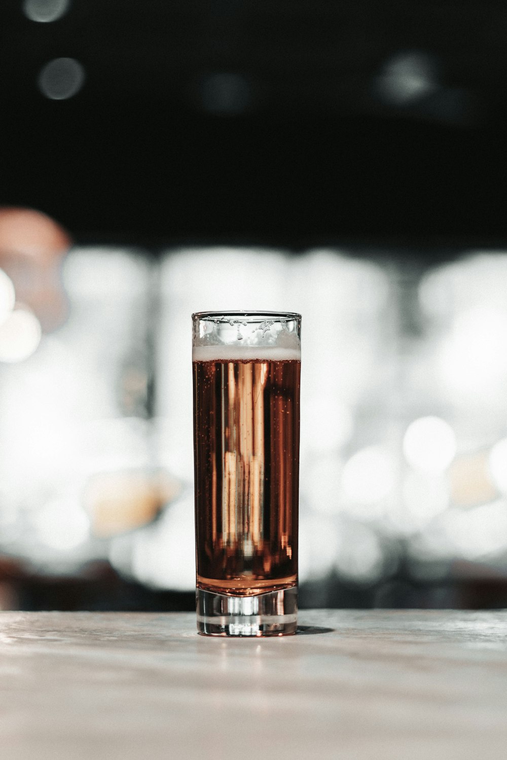 clear drinking glass with brown liquid