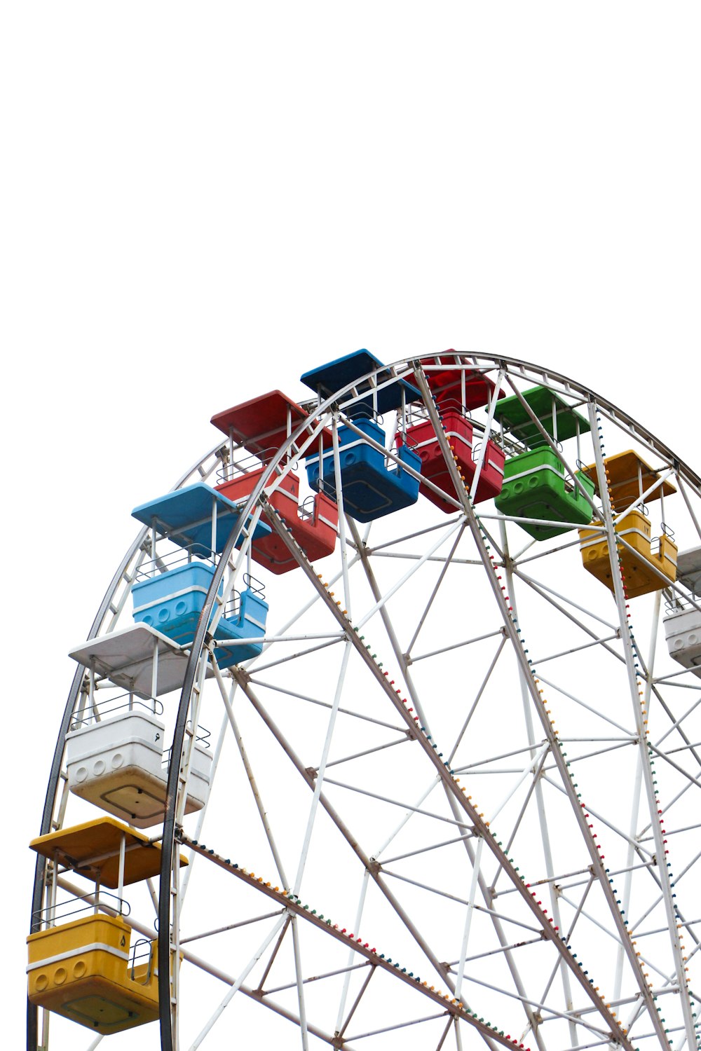 white and blue ferris wheel under white sky during daytime