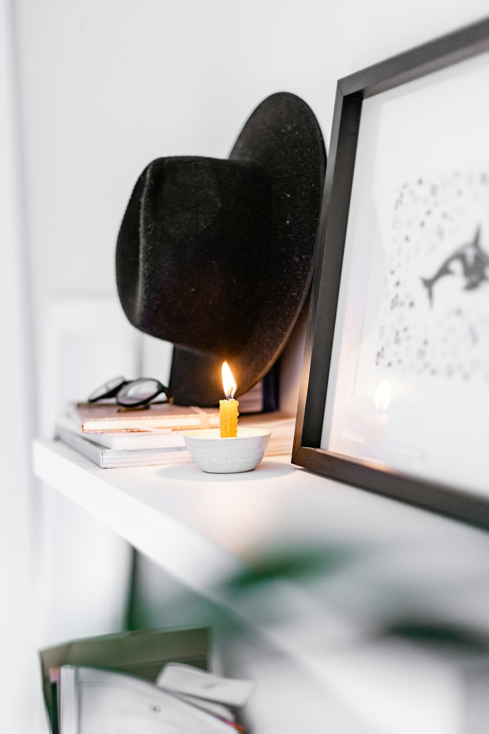 white candle on white wooden table