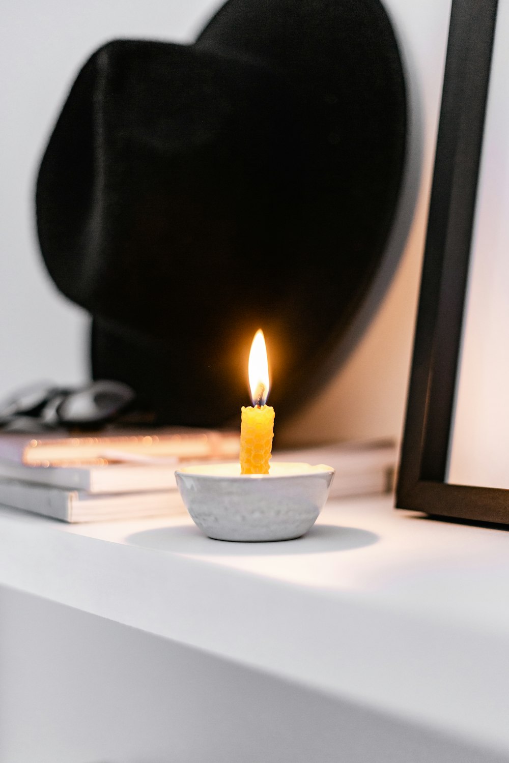 white candle on brown wooden holder
